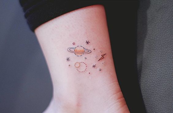 Minimal space tattoo on the ankle