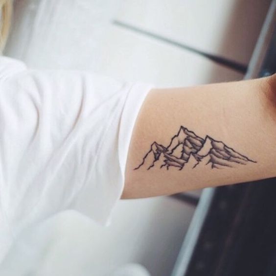 Mountains tattoo on the inner arm