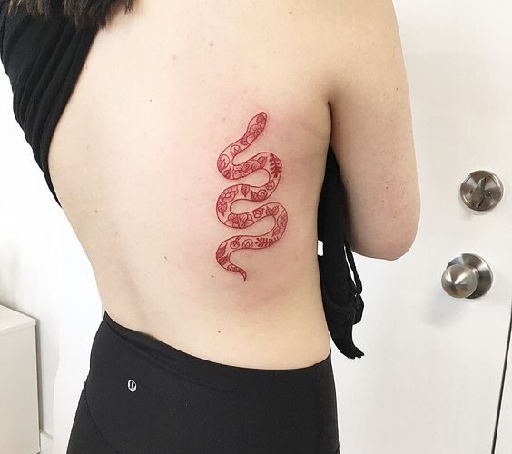 Red snake tattoo on the right rib cage