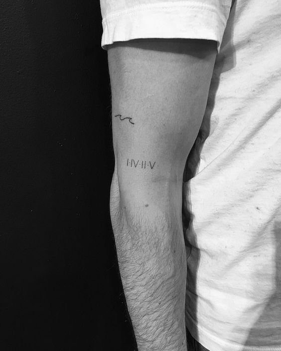 Roman numerals date tattoo on the arm