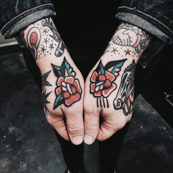 Roses tattoos on both thumbs