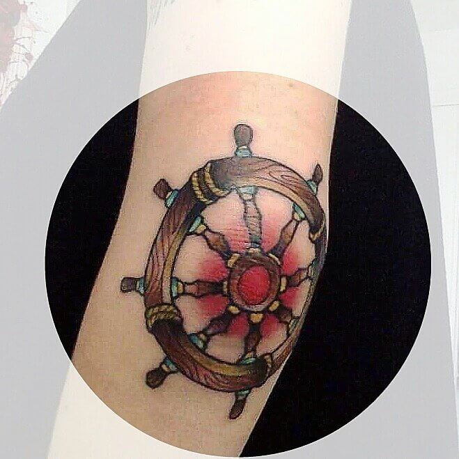 Ships wheel tattoo on the elbow