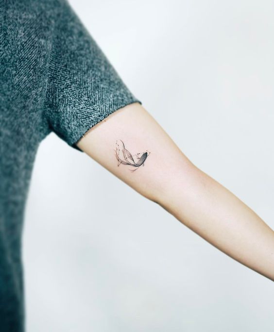 Small fish tattoo on the inner arm