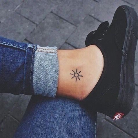 Small sun tattoo on the ankle