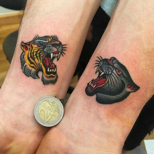 Small traditional panther tattoos on the wrists
