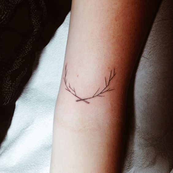 Small twig tattoo on the arm