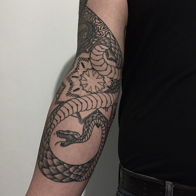 Snake surrounds the mandala on this awesome piece on inner arm