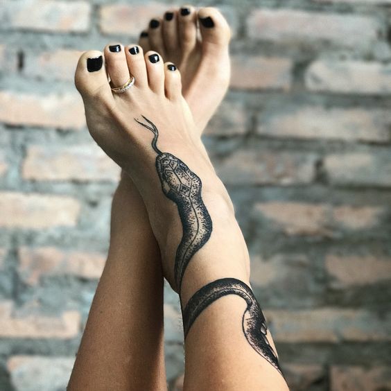 Snake tattoo over the leg and the foot