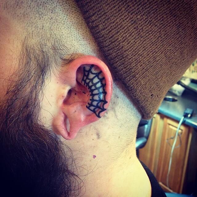 Spider web tattoo on the ear by Rich Hadley