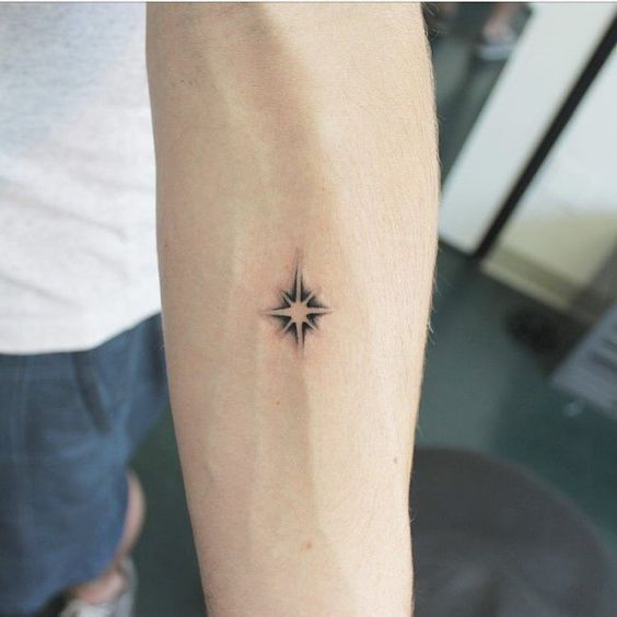 Star tattoo on the inner forearm