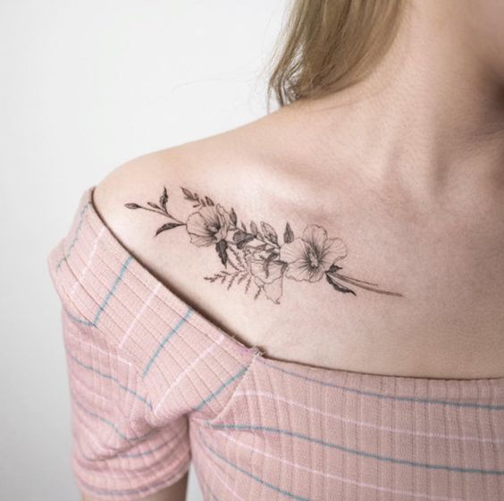 Subtle floral bouquet tattoo on the collarbone