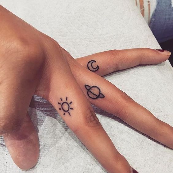 Sun saturn and moon tattoo on the fingers