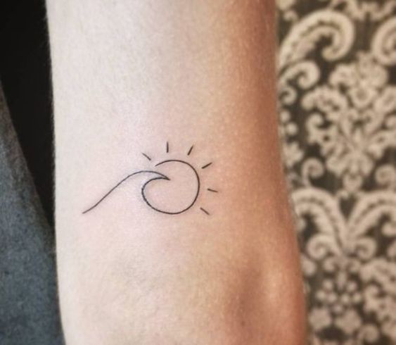 Sun tattoo together with a wave