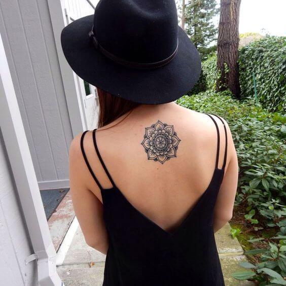 Superb black mandala tattoo on the upper back