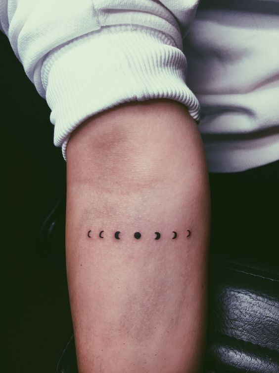 Tiny moon phase tattoo on the inner arm