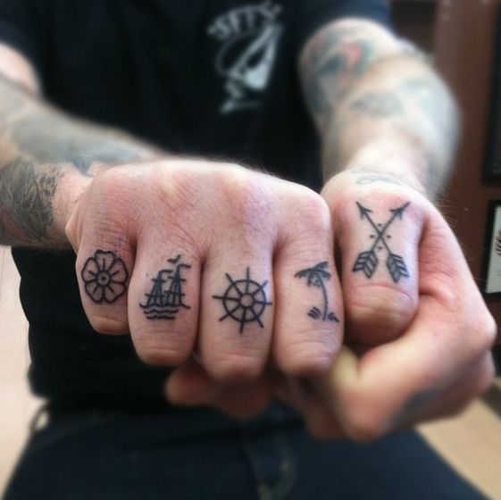 Tiny traditional tattoos on the fingers