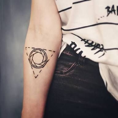 Triangle tattoo with a aperture inside