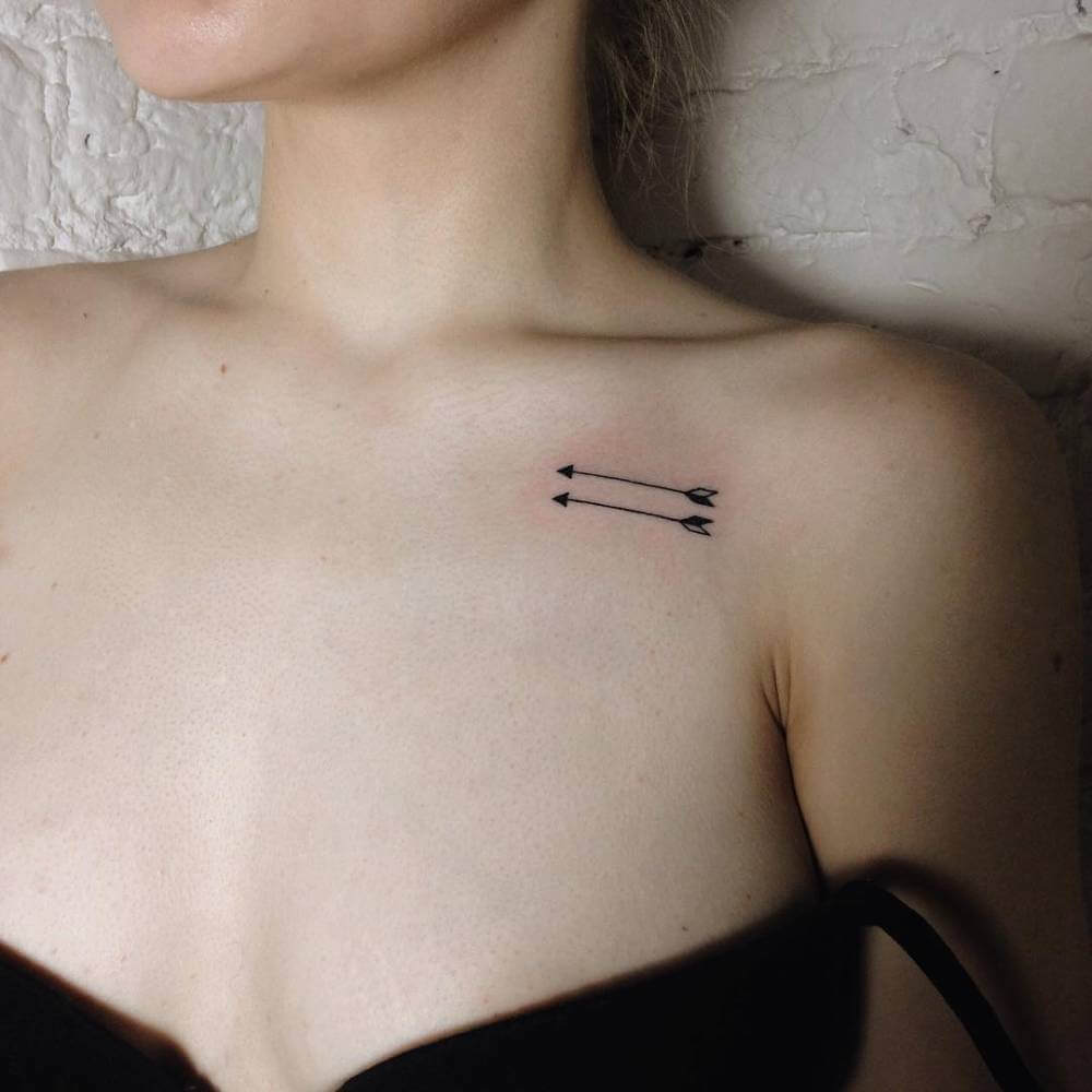 Two arrows tattoo on the clavicle by tattoois Ann Pokes