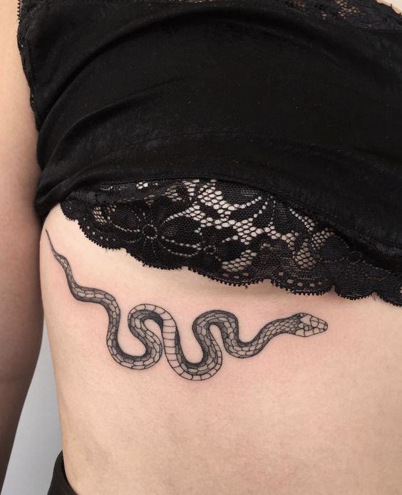 Underboob black snake tattoo