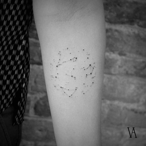 Various constellation tattoos on the left inner forearm