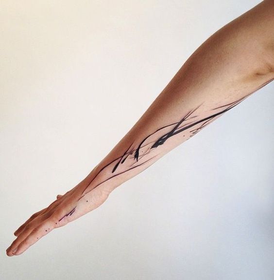 Abstract brush strokes tattoo on the arm