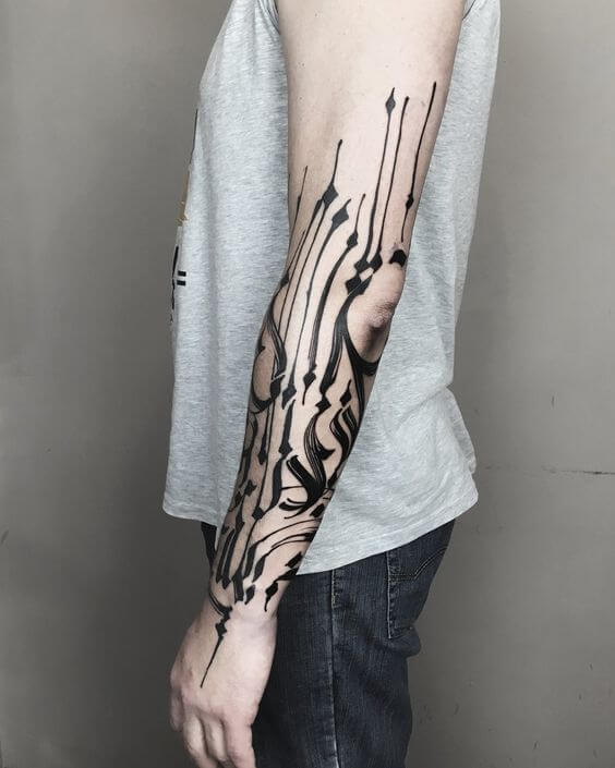 Abstract calligraphy tattoo on the arm by Teti Malik