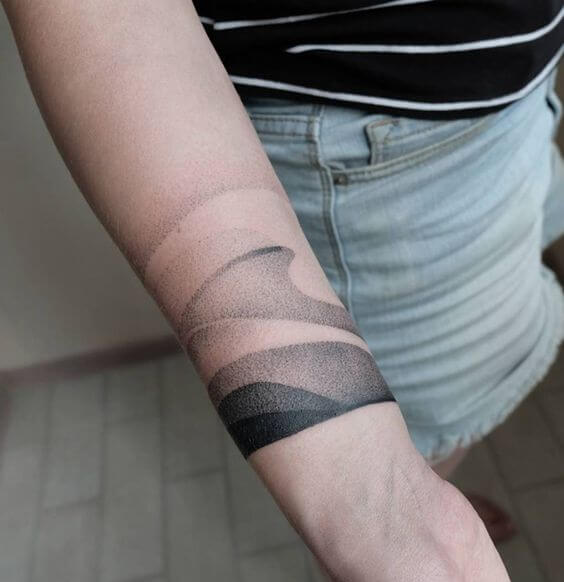 Black dotwork gradient tattoo on the inner arm