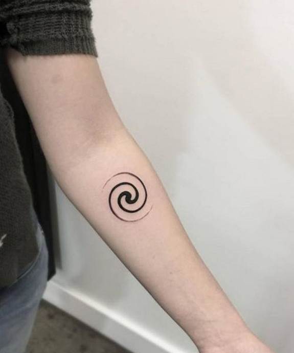 Black spiral galaxy tattoo on the arm