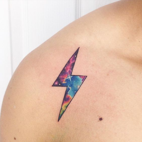 Lightning bolt tattoo with galactic scenery on the right shoulder