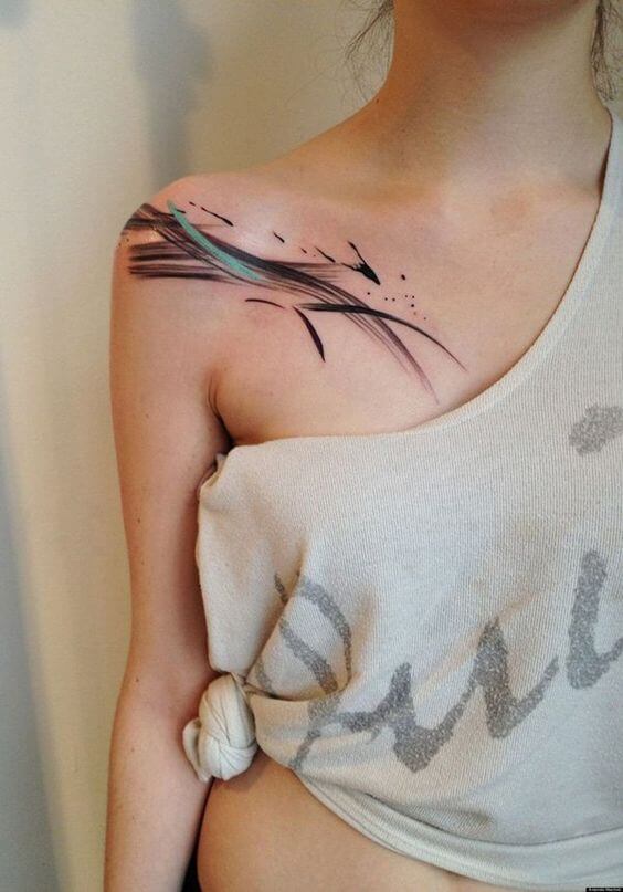 Paint brush stroke tattoo on the shoulder and chest