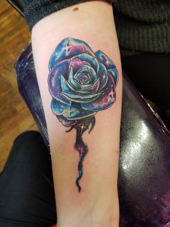 Rose galaxy tattoo on the right inner arm