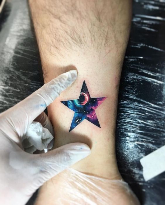 Star tattoo filled with galaxies by Adrian Bascur