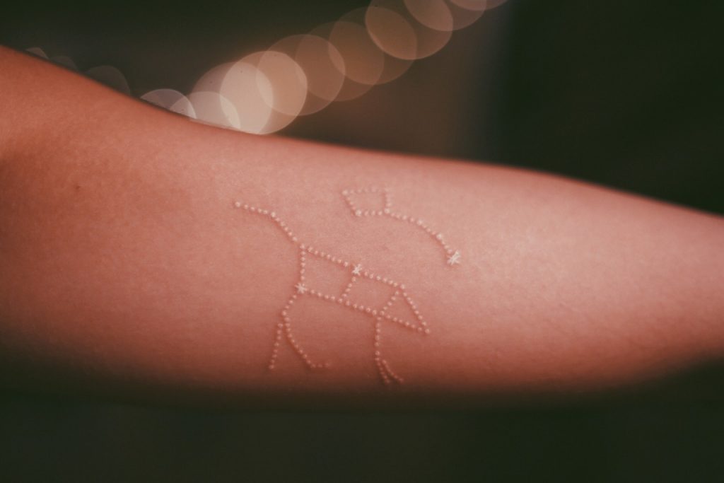 Stick and poke white tattoo of Ursa Major and Ursa Minor constellations