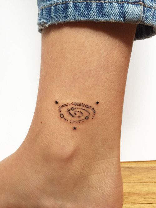 Tiny galaxy tattoo on the inner ankle