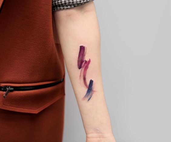 Violet and pink watercolor brush stroke tattoo by Georgia Grey