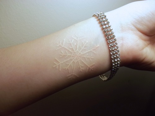 White snowflake tattoo on the wrist
