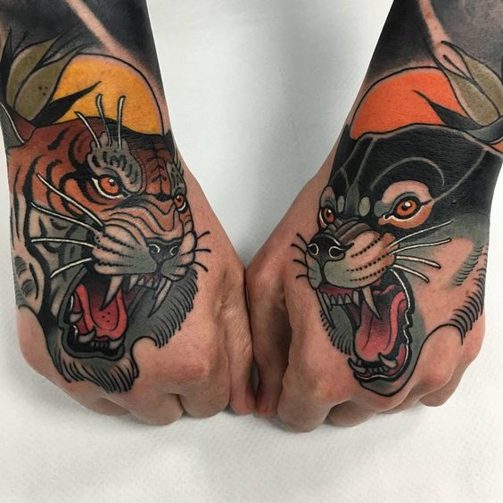 Wolf and tiger tattoo on the hands by tattooist Toni Donaire