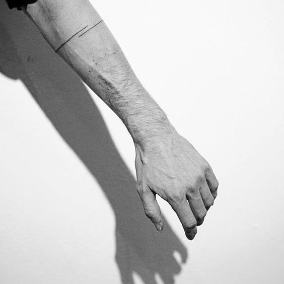A thin black line armband tattoo spencer hansen minimal