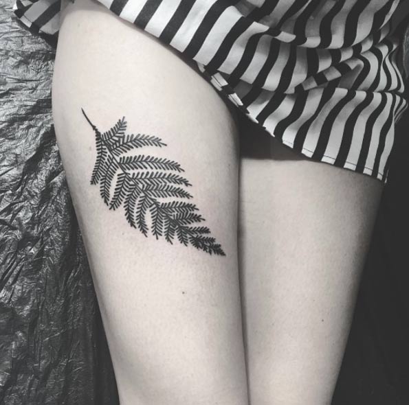 Another black fern tattoo on the right thigh