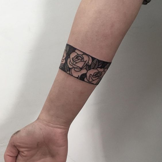 Another negative space armband roses tattoo