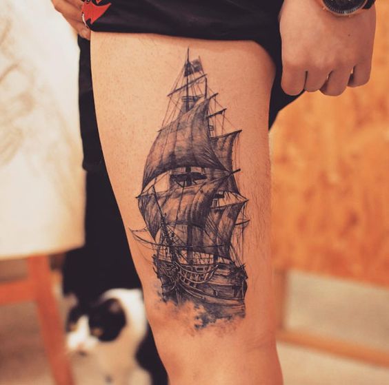 Another realistic black tattoo of a ship on the left upper thigh by tattooist grain