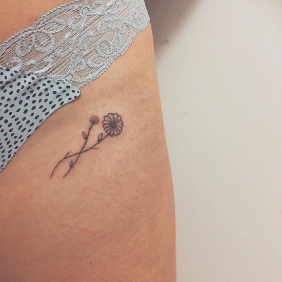 Another tiny flower tattoo on the hip