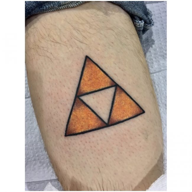 Another traditional style golden triforce tattoo on the leg