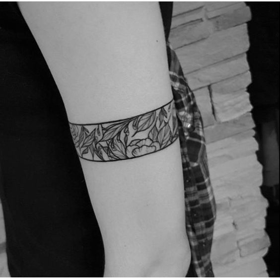 Armband tattoo with botanical motifs