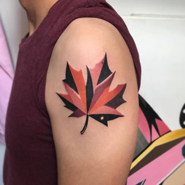 Autumn colored maple leaf tattoo on the left bicep