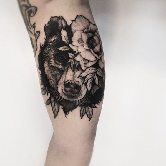Bear and flower tattoo on the arm