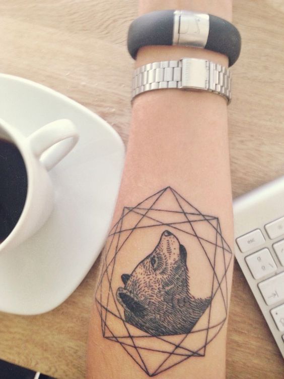 Bear head and icosidodecahedron tattoo on the left arm