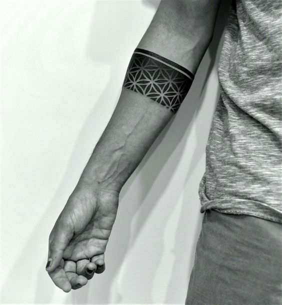 Beautiful black tattoo of a sacred geometry armband