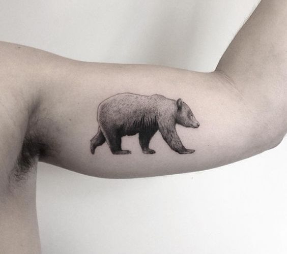 Black and grey bear tattoo on the left bicep