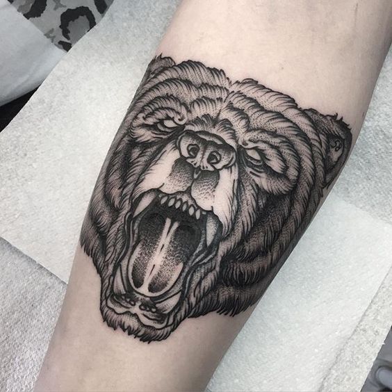 Black dotwork bear head tattoo on the right inner arm